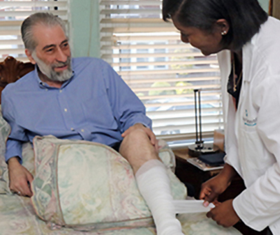 Four Seasons nurse attending to an older man.