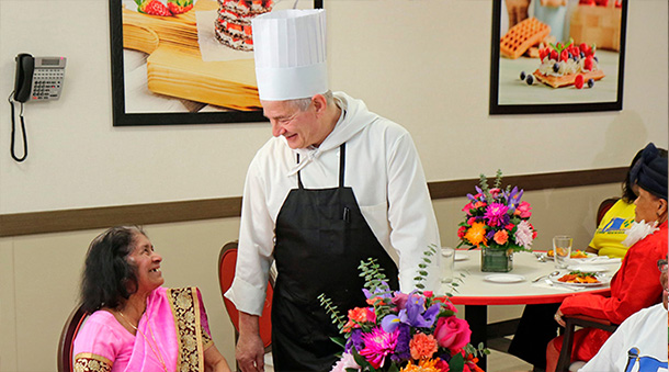 Chef talking to a woman in the Four Season Adult Day Care dining room.