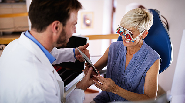 Doctor conducting an eye test on an older woman.