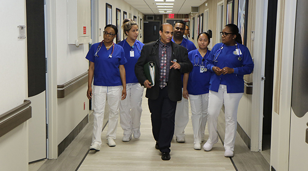 Group of Four Seasons doctors and nurses walking down the hall.