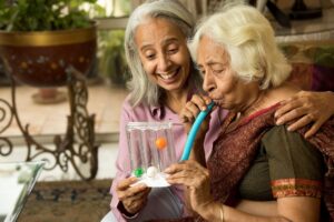 Older woman works with a home health care worker.
