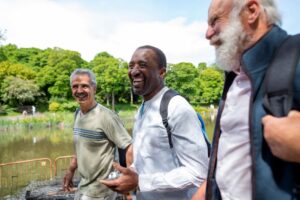 Three older men going for a hike and laughing