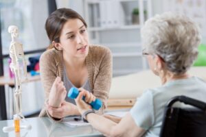 An older woman does physical therapy to protect her bone health.