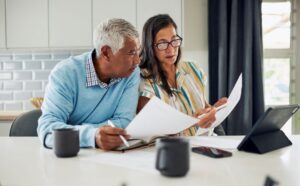 An older woman and man plan for their future.