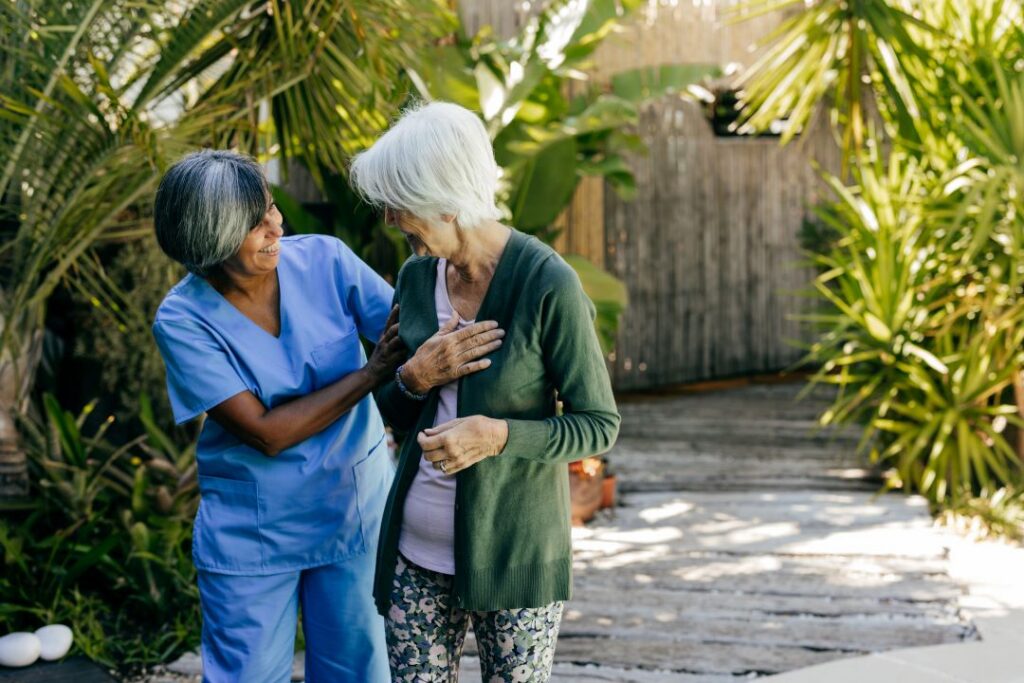 A rehab therapist works with an older woman.