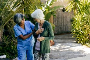 A rehab therapist works with an older woman.