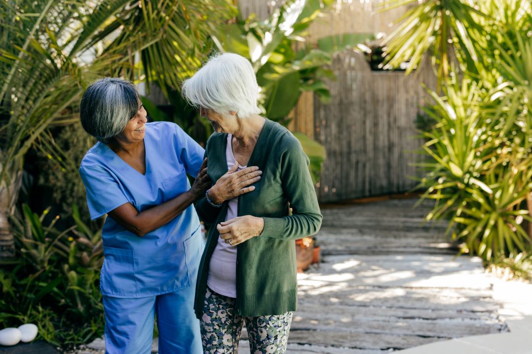 A rehab therapist works with an older woman.
